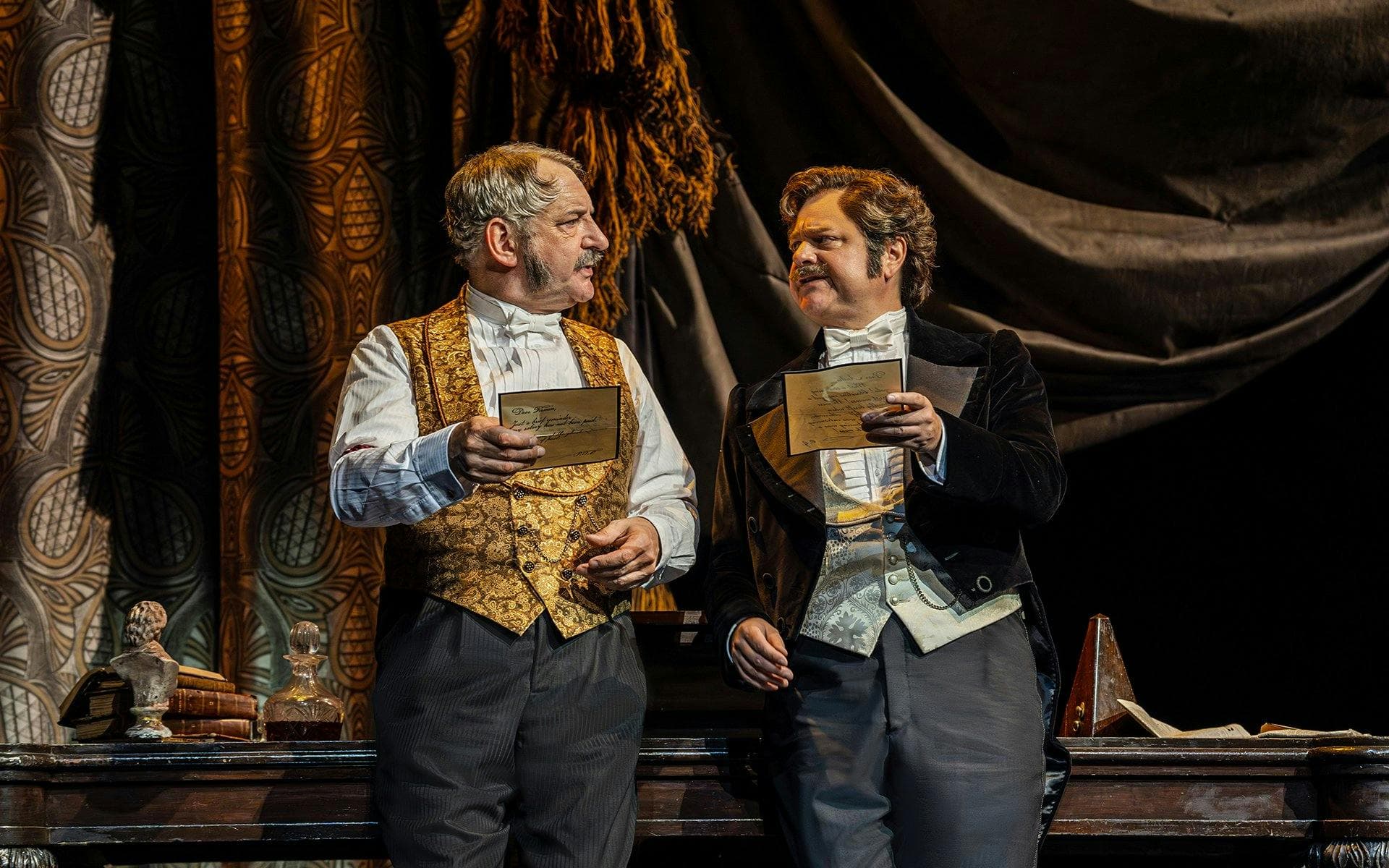 cd59fea4-af72-45b4-a681-d052ee8de35e-1775559481754-Martin Ball as Monsieur Firmin & Adam Linstead as Monsieur André. Photo by Johan Persson